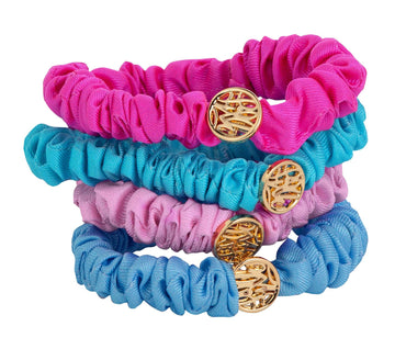 Lilly Pulitzer front view of four satin scrunchies showing colors and packaging benefit