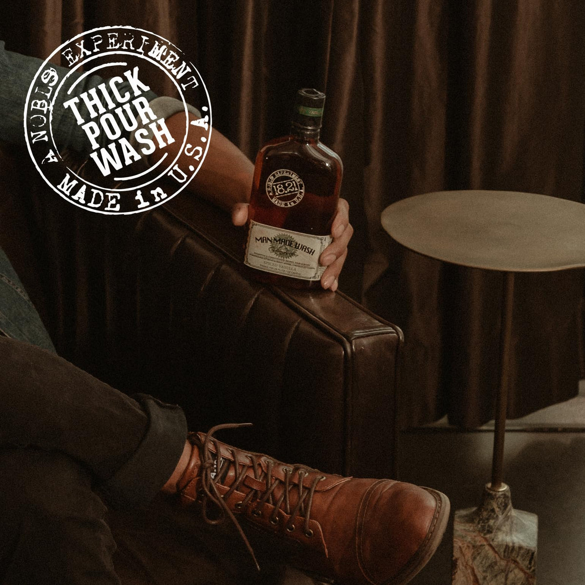 18.21 Man Made bottle staged in a bathroom lifestyle setting suggesting rugged, fireside-inspired scent