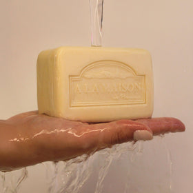 A LA MAISON bar on shower shelf, showing practical everyday use convenience