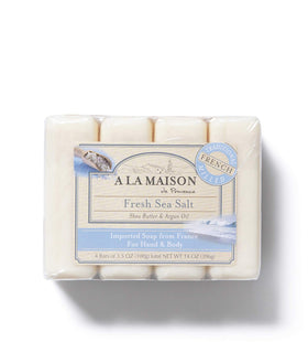 A LA MAISON bar in hand producing foam to show gentle cleansing benefit