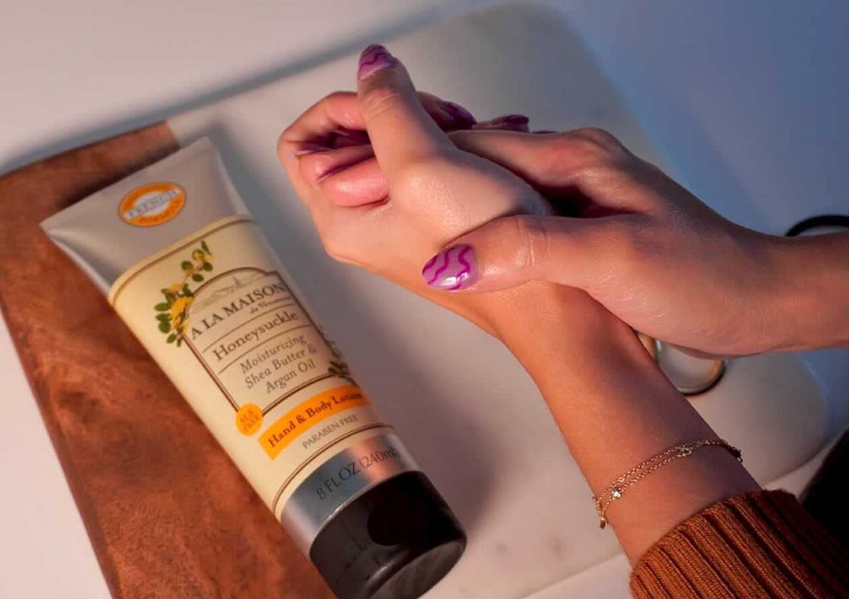 A LA MAISON honeysuckle next to a sunscreen bottle to show the 8 oz travel-friendly scale and portability