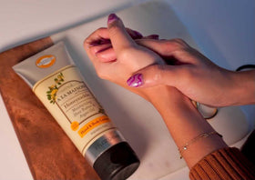 A LA MAISON honeysuckle next to a sunscreen bottle to show the 8 oz travel-friendly scale and portability