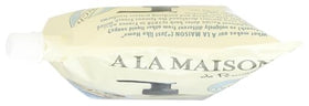 A LA MAISON pouring refill into bottle demonstrating spill-free refill