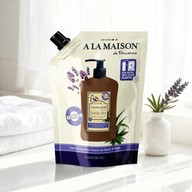 A LA MAISON pouring refill into dispenser for easy sustainable refill