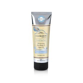 A LA MAISON front bottle showing sea salt lotion and fresh coastal design, highlights quick absorption