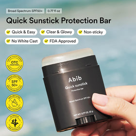 Applying Abib sunstick to cheek for quick sun protection and glow