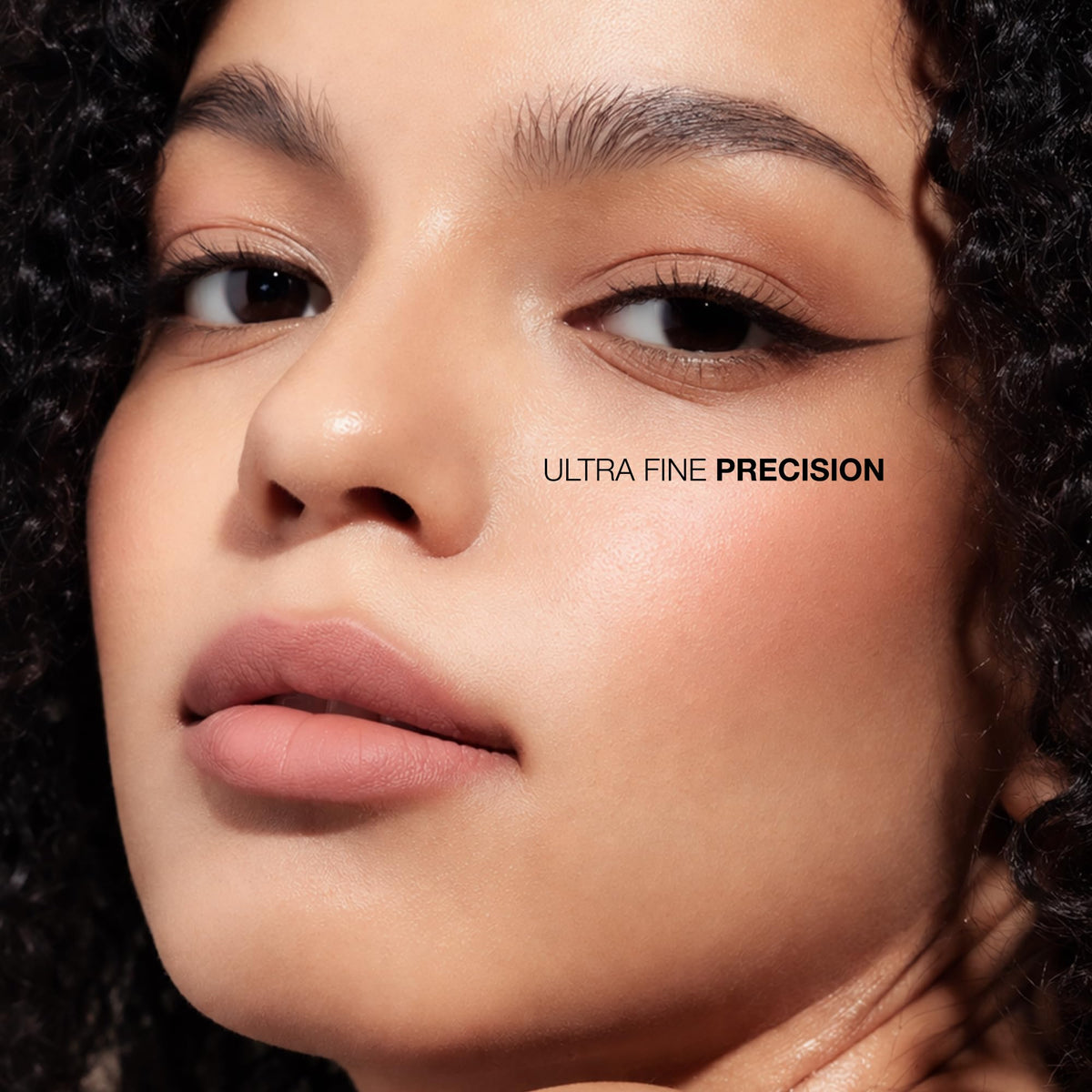 Absolute New York model applying winged liner showing crisp edge and long-wear definition benefit