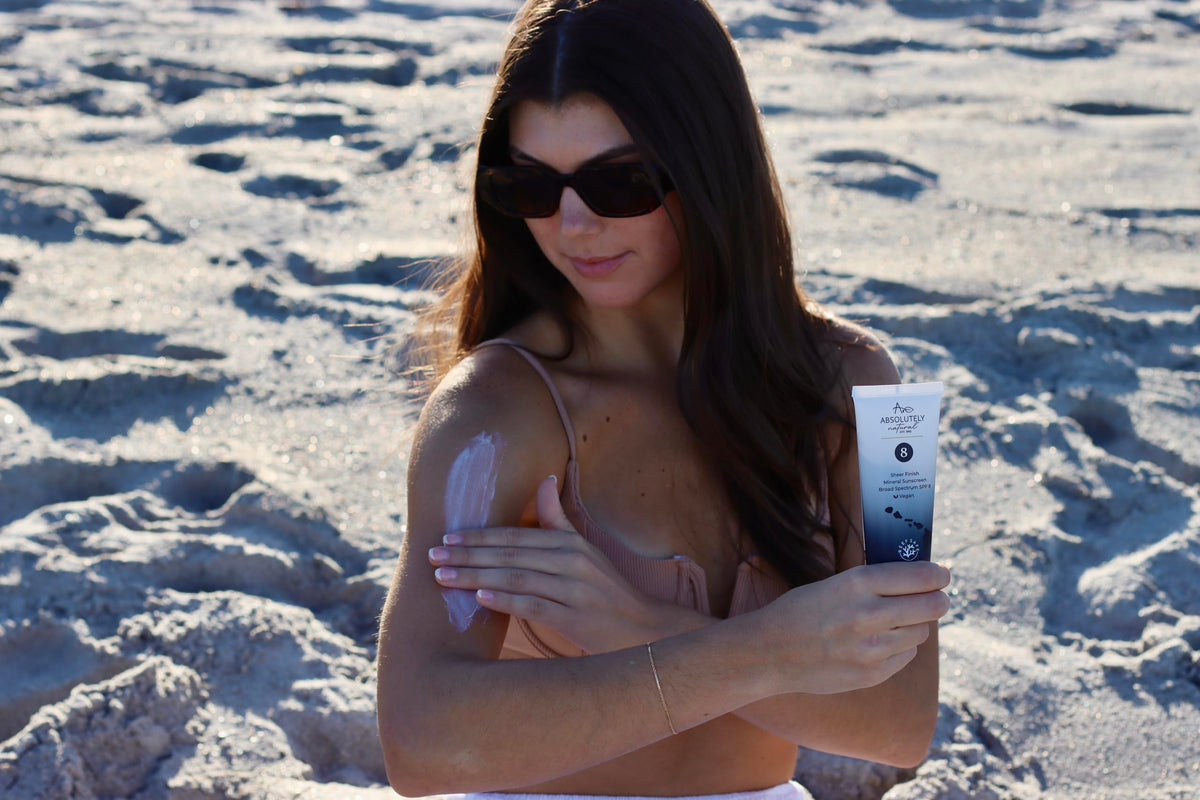 Spreading Absolutely Natural SPF 8 on arm for even, hydrating coverage
