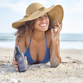 Absolutely Natural in a beach setting showing reef-safe outdoor tanning use