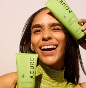 Acure conditioner being applied to mid-lengths for detangling benefit