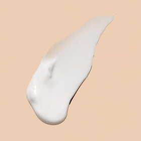 Applying Acure eye cream under eye to demonstrate gentle hydration