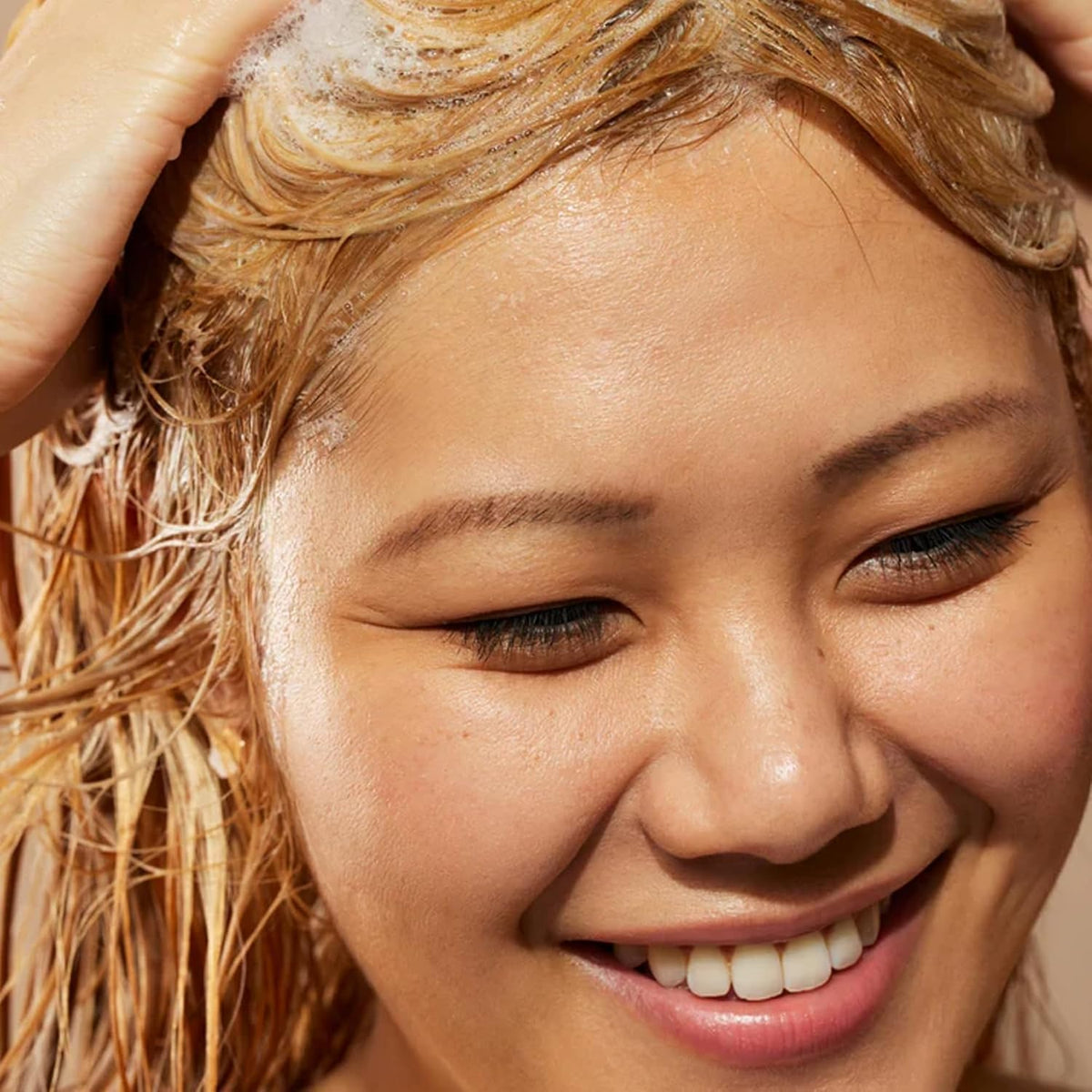 Acure shampoo lather in hand demonstrating gentle cleansing action