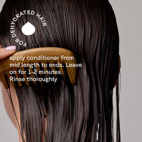 Acure conditioner applied in shower demonstrating easier detangling benefit