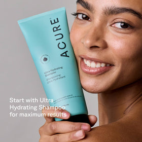 Acure 8 fl oz bottle next to everyday items conveying true size and portability
