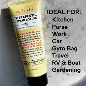 Adamia tube next to smartphone showing compact 4 oz travel-friendly size