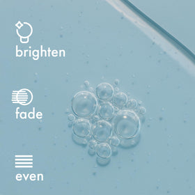 Admire My Skin bottle by mirror in lifestyle scene conveying brightening results