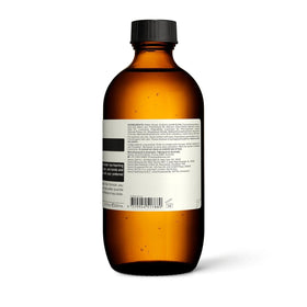 Aesop bottle with recycled plastic badge illustrating sustainable packaging benefit