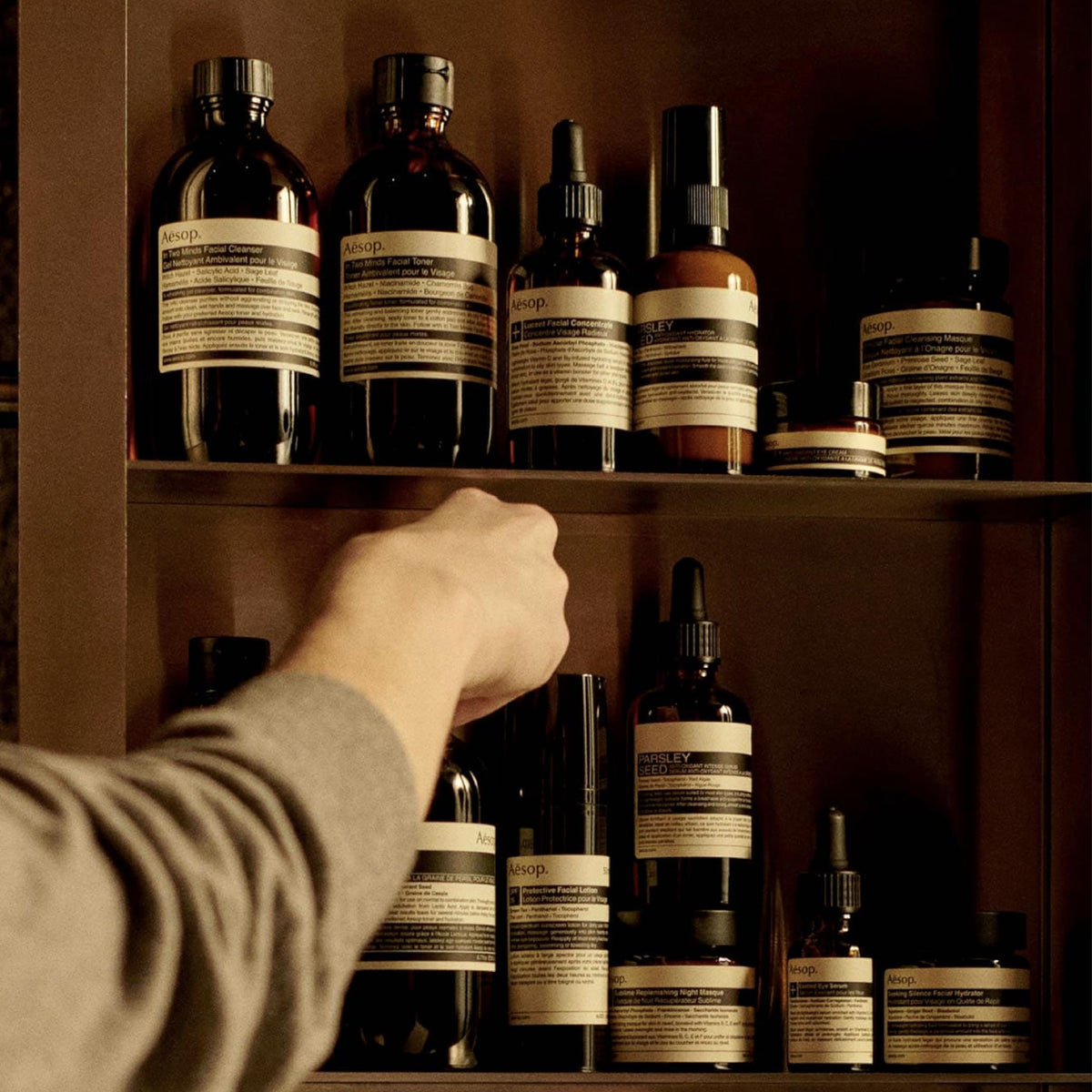 Aesop 200 mL bottle beside everyday items showing travel-friendly scale benefit