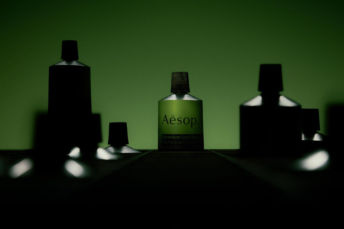 Aesop balm on bathroom shelf in lifestyle scene suggesting daily routine use