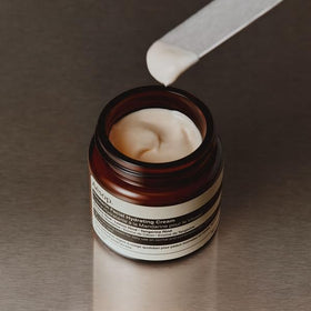 Aesop mandarin cream bottle with recycled-plastic symbol emphasizing sustainable packaging