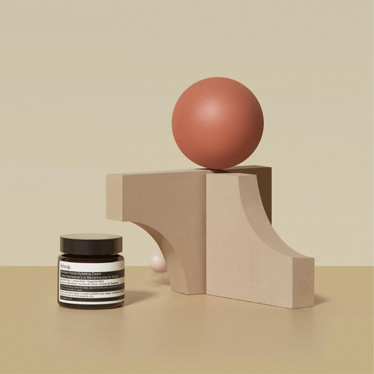 Aesop mandarin cream beside a ruler showing 60 mL size for scale and portability