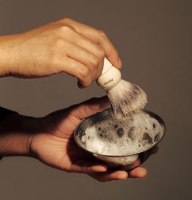 Aesop serum with shaving brush illustrating richer lather and improved glide