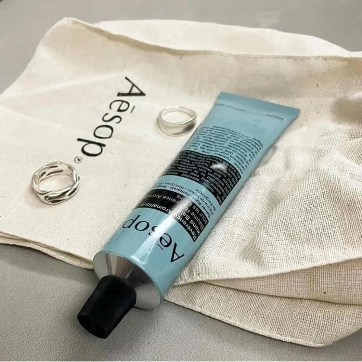 Aesop Reverence being applied to hands to show smoothing effect on dry skin