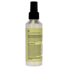 AG Care COCO misting into curly hair to detangle and add lightweight moisture