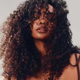 AG Care in-shower hair application demonstrating smoother curl definition