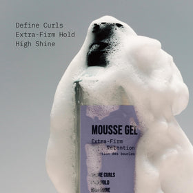 AG Care mousse being applied to damp curls for even distribution and hold