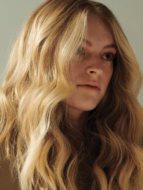 AG Hair Sea Spray applied to wavy hair in sunlight, creating volume and matte definition