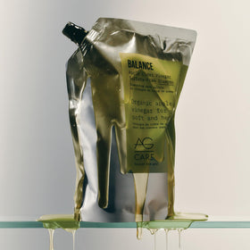 AG Care in bathroom lifestyle styling showing glossy frizz-free hair