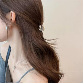 Agirlvct clips in a small pouch on a vanity, portable styling solution