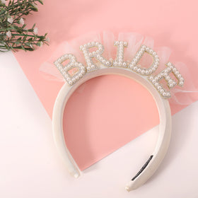 Agkvw headband held in hand to show scale and lightweight comfortable fit