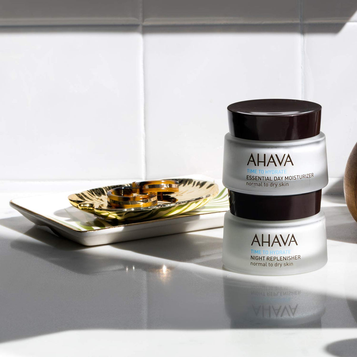 AHAVA jar held in hand for size comparison, convenient travel-friendly benefit