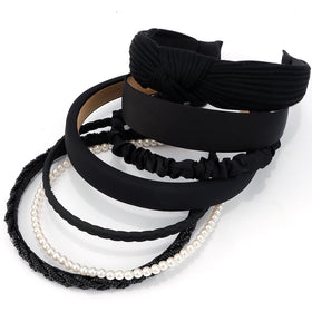 AHONEY headband next to a hand to show scale and universal fit