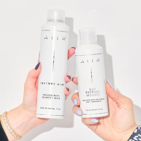 AIIR spray held in hand for scale showing convenient 7 oz travel-friendly benefit