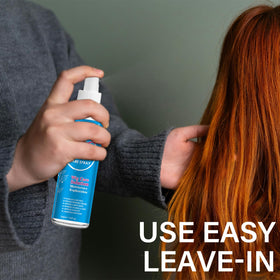 AKBAN being sprayed from hand to wig illustrating simple, precise application