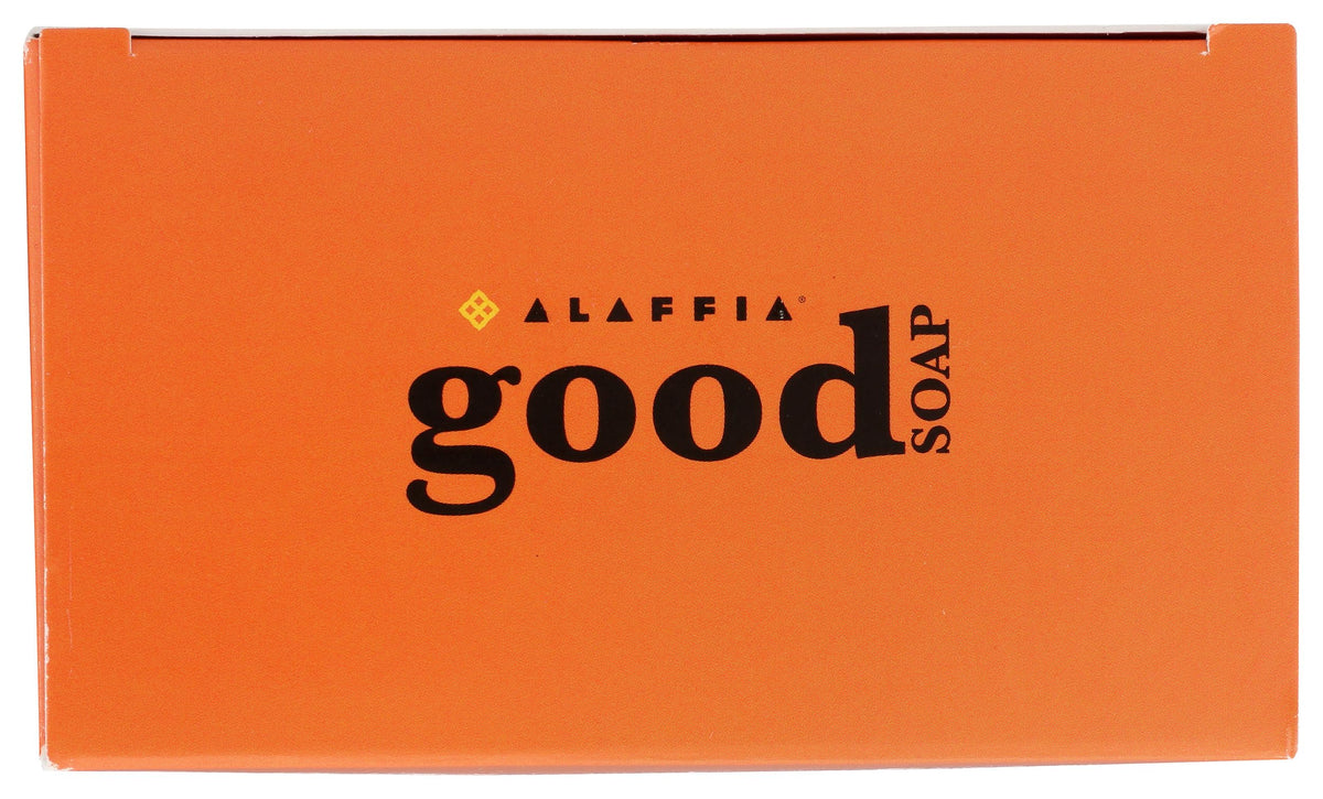 Alaffia soap held in hand to show 5-ounce bar size and easy portability