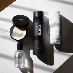 Alex Costa bottle on bathroom vanity with grooming tools for pre-styling preparation