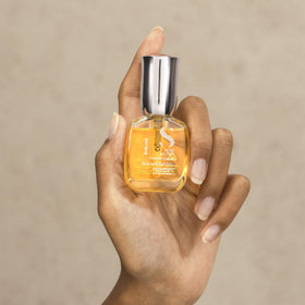 ALFAPARF MILANO bottle beside common items showing travel-friendly compact size
