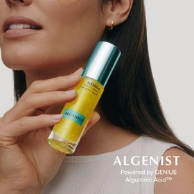 Algenist 2 oz bottle beside a hand for scale to confirm size before purchase
