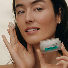 Algenist cream spread on hand close-up demonstrating cushion and quick blending benefit