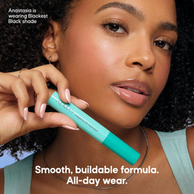 Almay mascara next to a ruler showing compact size for travel convenience