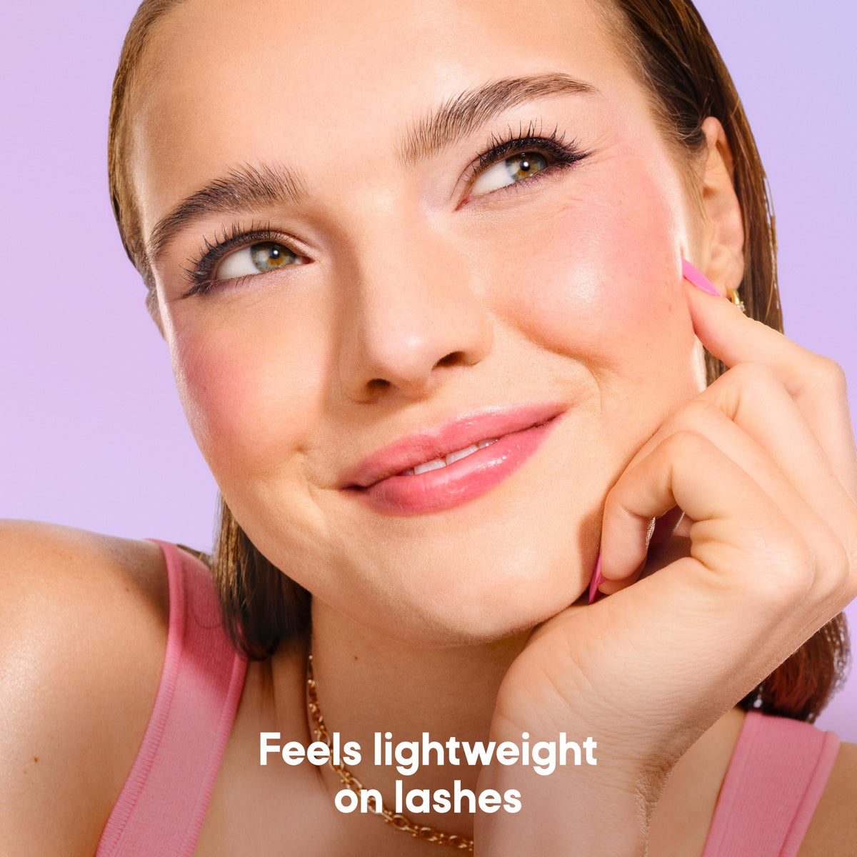 Almay mascara next to coin showing compact size and travel-friendly benefit