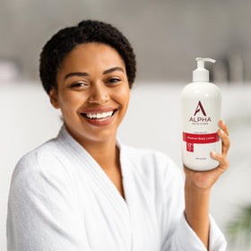 Person applying Alpha lotion on leg for smoother, hydrated skin