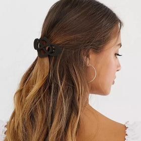 Amariver barrette securing half-up hairstyle showing neat hold benefit