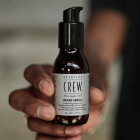 American Crew serum applied to palm showing easy spread and quick use