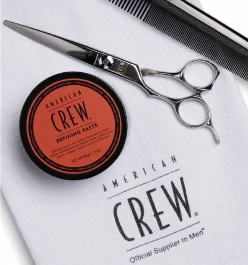 American Crew defining paste in hand demonstrating easy distribution and control