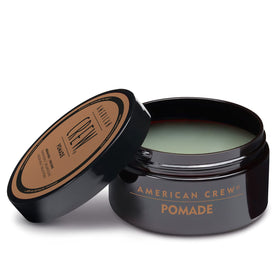 American Crew pomade on bathroom shelf in everyday grooming setup